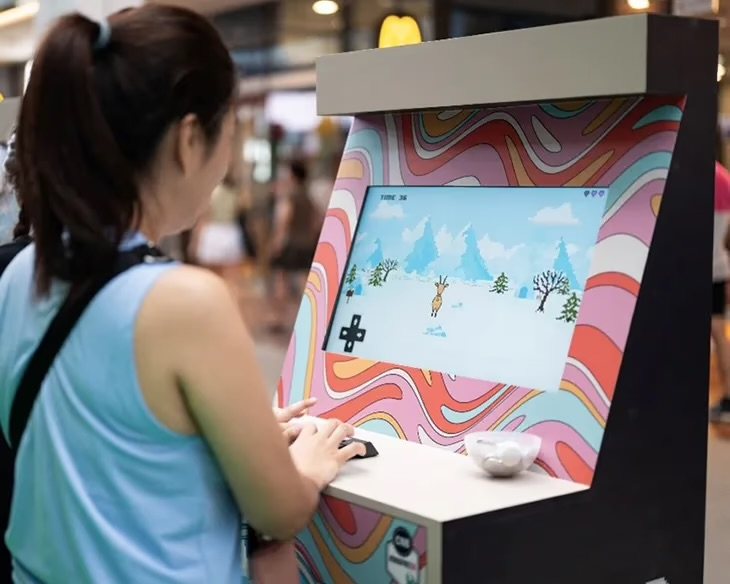 Visitor playing the arcade game